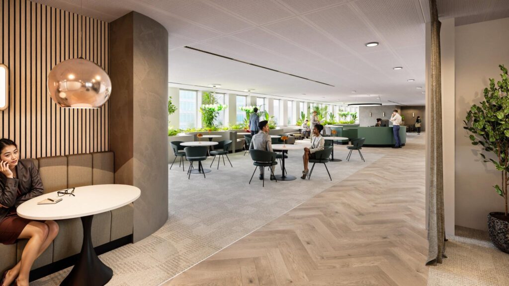 Modern office lounge area "De Entree" with people working and socializing in a bright, plant-filled environment.